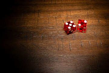 Professional casino-style dice on a wooden table with room for copy. 