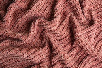 Beautiful pink knitted fabric as background, top view