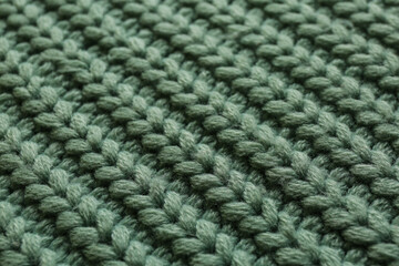 Beautiful pale green knitted fabric as background, closeup