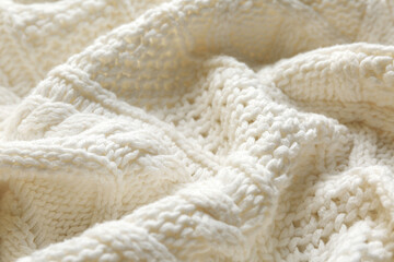Fototapeta na wymiar White knitted fabric with beautiful pattern as background, closeup