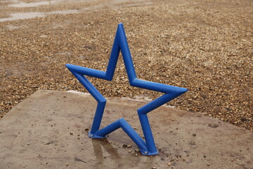 Steel star sculpture painted blue.