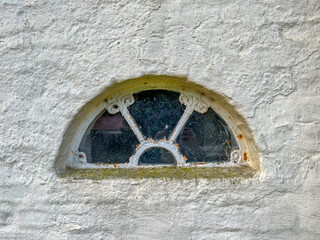 round vintage window in the wall