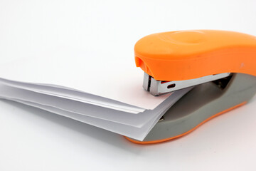 Stapling sheets of paper with an orange stapler