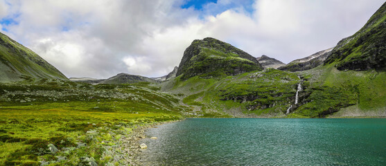 Panoramic view of blue glacial mountain lake