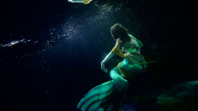 mysterious underwater world, magical mermaid is floating in depth, art and fantasy shot