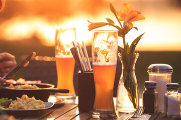 Beer and bavarian food in a beer garden at sunset