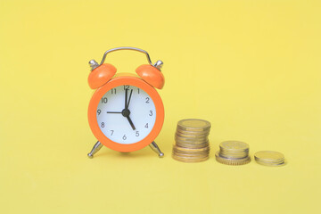 Business financial ideas concept with coins stack and alarmclock