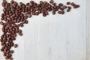 Designer frame made of coffee beans on a blue wooden table