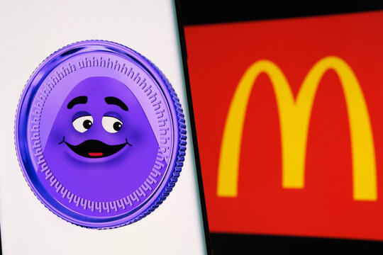 Grimace Coin seen on smartphone screen and blurred McDonald's logo on the background. Fake meme coin. Stafford, United Kingdom, January 30, 2022.