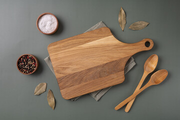 Wood cutting board and napkin on wooden table and spice, pepper, salt. - Powered by Adobe