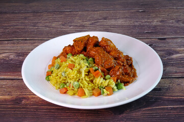 Chicken Tikka Masala with Turmeric Rice. Famous Indian cuisine, selective focus with copy space