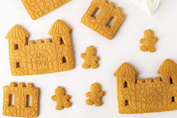 Christmas house from ginger cookies with ginger man outside decorated in Christmas