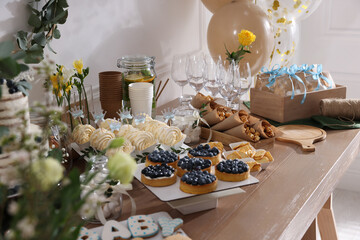 Tasty treats on table in room. Baby shower party