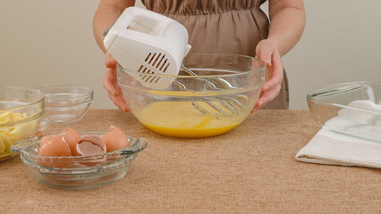 Apple cake with biscuit base recipe, step by step baking process. Ingredients close up on kitchen table