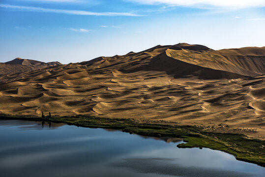 A view of the lake shore at the dunes of the Badain Jaran Desert in Inner Mongolia, China