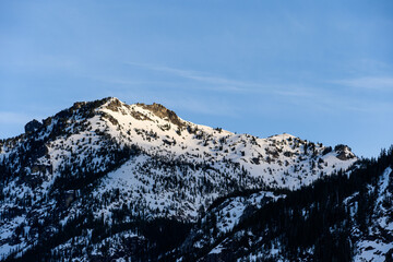 Denny Mountain in the Alpine Lakes Wilderness, just after sunrise on a clear blue sunny day, as a nature background
