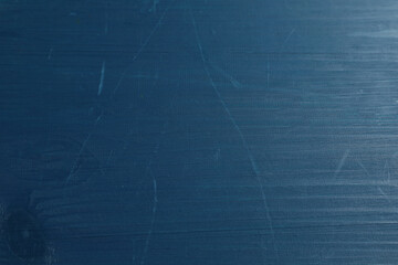Old blue wooden surface with scratches as background, closeup
