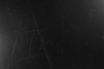 Old black surface with scratches as background, closeup