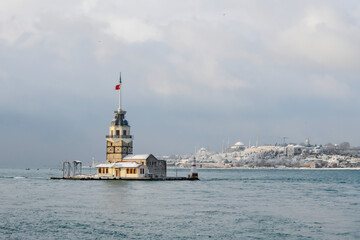 Magnific view of Maiden's Tower (aka Kiz kulesi) in winter day with many snow in Istanbul,Turkey. Istanbul's main attractions. 