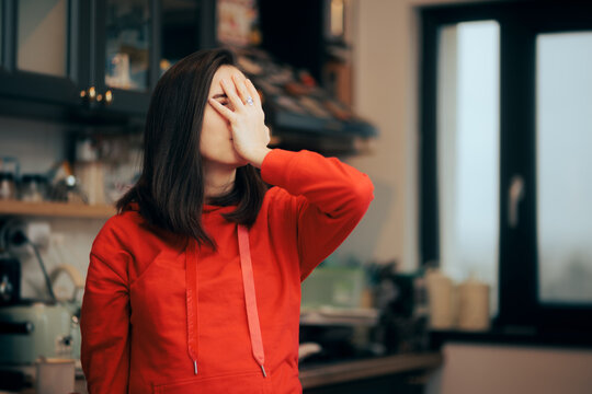Stressed Woman Making Face Palm Gesture Standing in the Kitchen