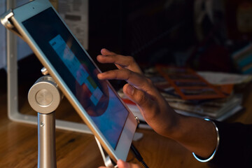 Restaurant employee using POS point of sale system on digital tablet