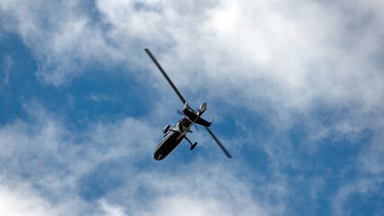 Fototapeta na wymiar Ultralight helicopter flying over the beach in Tamarindo, Costa Rica