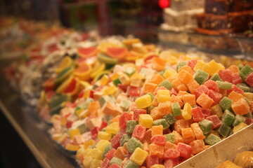 colorful delicious marmalade jelly candies on counter of shop, grocery, market, cafe - close up view. Dessert, sale, sweet food and confectionery concept