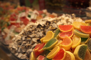 colorful delicious marmalade jelly candies on counter of shop, grocery, market, cafe - close up view. Dessert, sale, sweet food and confectionery concept
