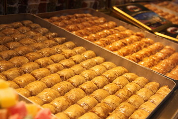 colorful delicious baklava dessert on counter of shop, grocery, market, cafe - close up view. Dessert, sale, sweet food and confectionery concept
