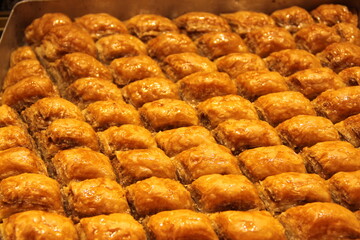 colorful delicious baklava dessert on counter of shop, grocery, market, cafe - close up view. Dessert, sale, sweet food and confectionery concept