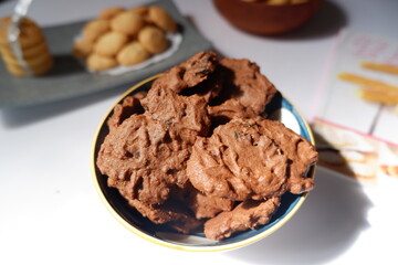 homemade chocolate cookies in a bowl, on a gray background. snacks, biscuits, made from flour, eggs, and sugar are eaten at tea time. snack time. close up
