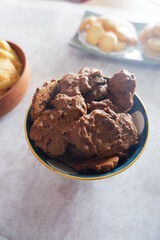 homemade chocolate cookies in a bowl, on a gray background. snacks, biscuits, made from flour, eggs, and sugar are eaten at tea time. snack time. close up
