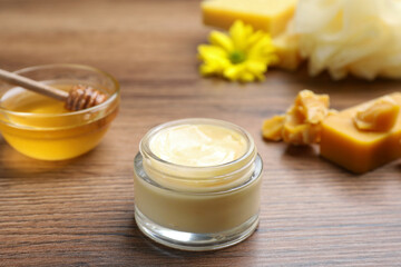 Cream with natural beeswax component on wooden table