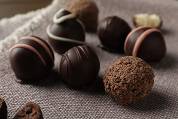 Many different delicious chocolate truffles on kitchen towel