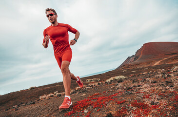 Running marathon man runner sport athlete training ultra running on long distance endurance trail...