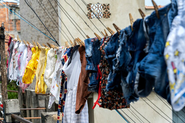Different clothes hanging on a clothesline. Clothing industry.