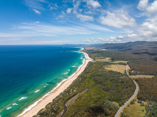 Stunning high angle aerial panoramic drone view of Lagoons Beach Conservation Area and the A3...