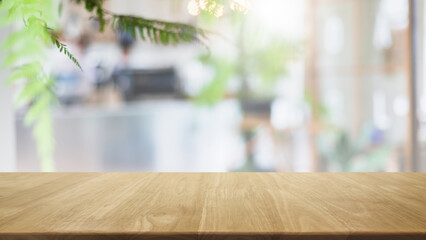 Empty wood table top and blurred coffee shop, cafe and restaurant interior background - can used for display or montage your products.