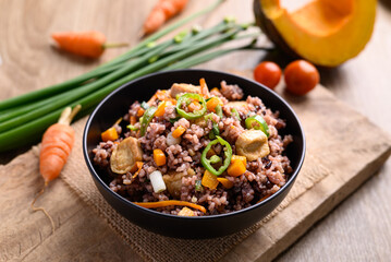 Fried purple rice with tofu, carrot, pumpkin and chili pepper. Healthy Asian vegan food