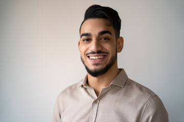 Obraz premium Headshot portrait of young adult smiling Indian man over blank copy space