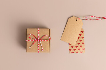 Vintage paper label with a red heart. Hand drawn retro tag or banner with a rope. Isolated on beige...