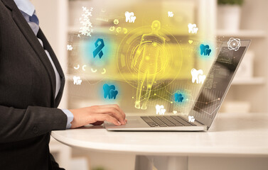 Doctor working on laptop with healthcare concept