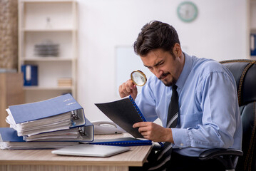 Young male employee working in the office