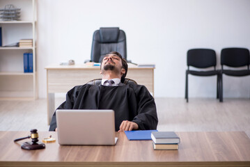 Young male judge working in the courthouse