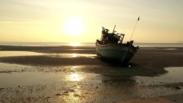 Round a bout flying - Sunset scenes of boat wreck along shore side - Nathon harbour - Koh Samu Island in Thailand