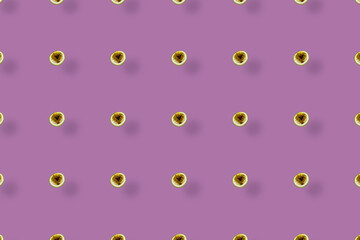 Colorful fruit pattern of fresh passion fruit on purple background with shadows. Top view. Flat lay. Pop art design