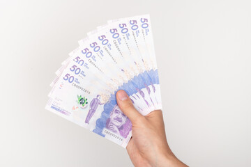 Hand holding colombian money