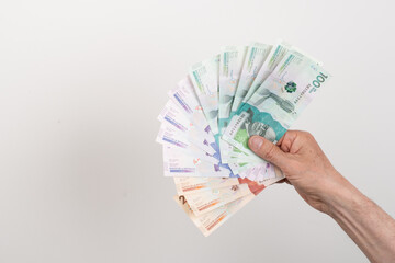 Hand holding colombian money
