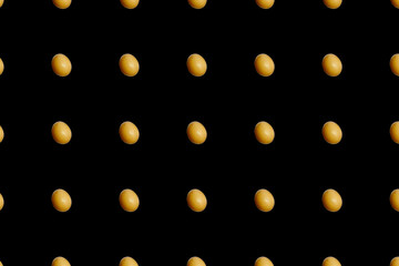 Colorful pattern of chicken eggs on black background. Top view. Flat lay. Pop art design