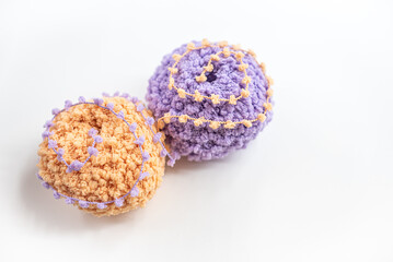 A lot of colorful wool balls of knitted yarn on a white background. The concept of handmade work, needlework and the sale of thread. Balls of alpaca wool, made by hand and colored with plant extract.